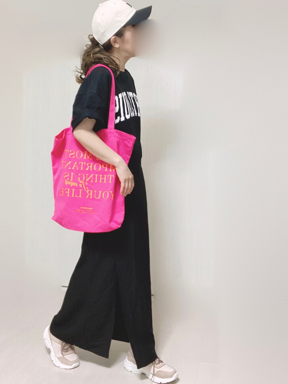 ブラック系のスカート、ピンク系のスニーカー、ブラック系のTシャツ/カットソーを着用したレディースの夏コーディネートの3枚目の写真