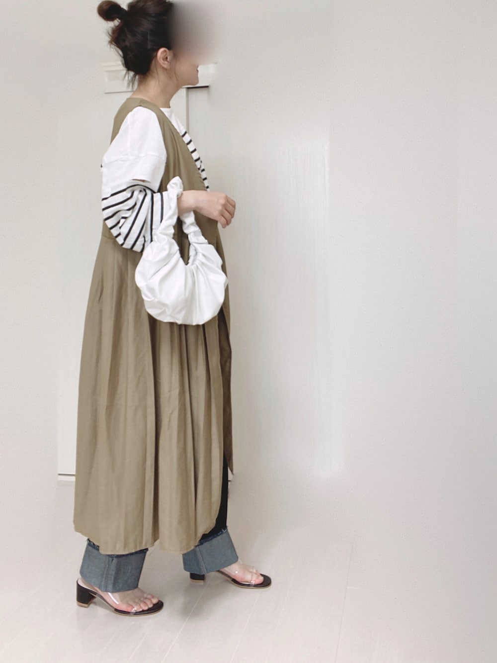 ベージュ系のワンピース、ブラック系のTシャツ/カットソー、ブルー系のデニムパンツを着用したレディースの夏コーディネートの4枚目の写真