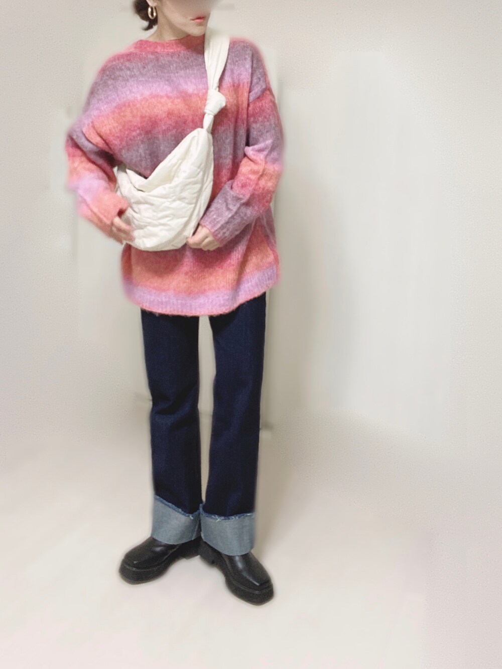 ピンク系のカーディガン/ボレロ、ホワイト系のショルダーバッグ、ブルー系のデニムパンツを着用したレディースの秋コーディネートの2枚目の写真