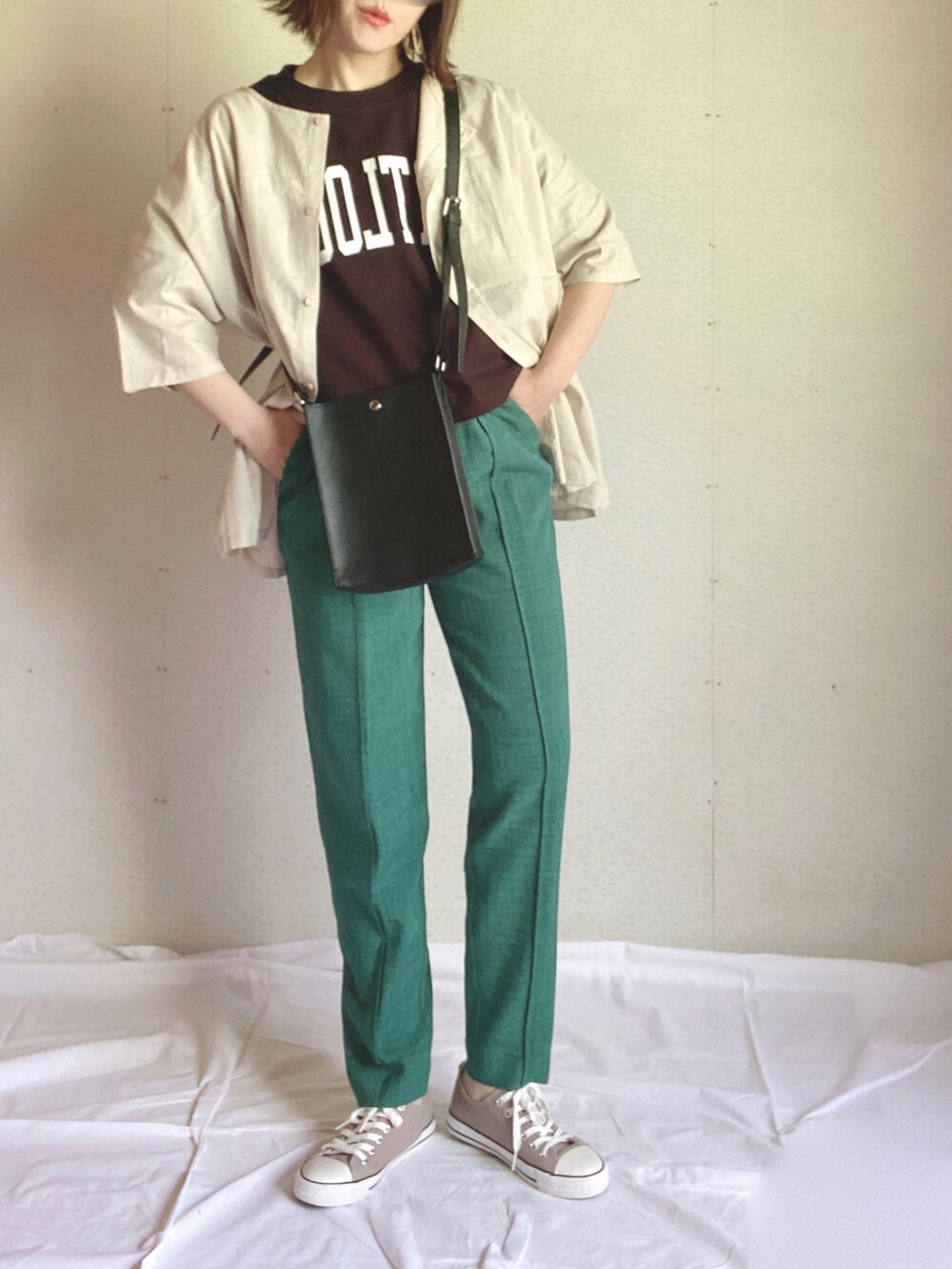 ブラック系のTシャツ/カットソー、ベージュ系のチュニック、ブラック系のショルダーバッグを着用したレディースの夏コーディネートの2枚目の写真