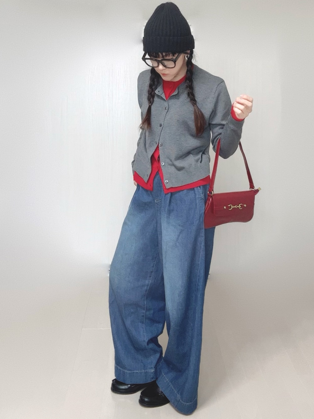 グレー系のカーディガン/ボレロ、ブラック系のローファー、ブルー系のデニムパンツを着用したレディースの春コーディネートの2枚目の写真