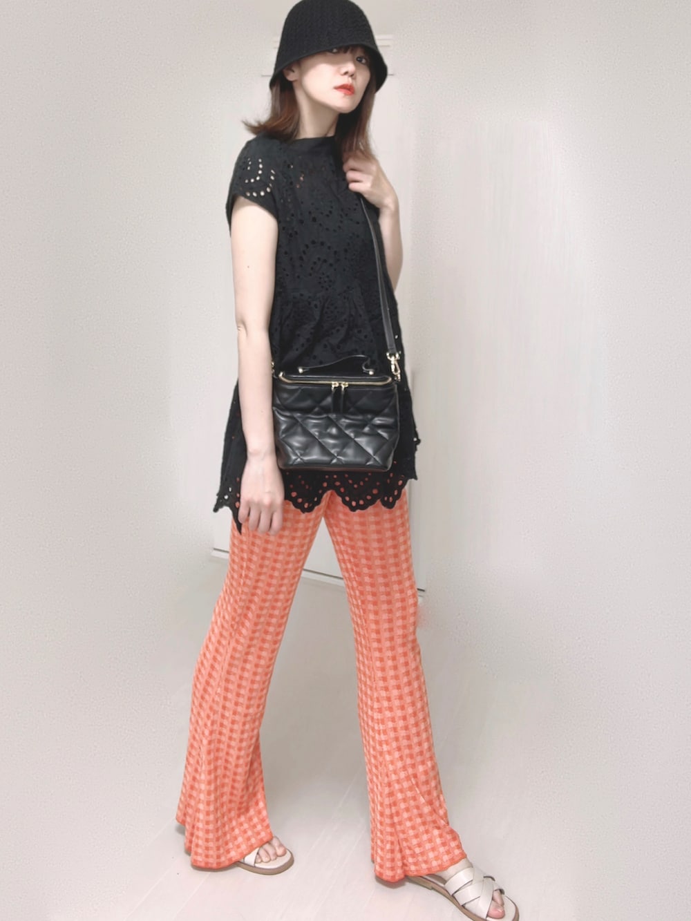 ブラック系のシャツ/ブラウス、オレンジ系のその他パンツ、ホワイト系のトートバッグを着用したレディースの夏コーディネートの4枚目の写真