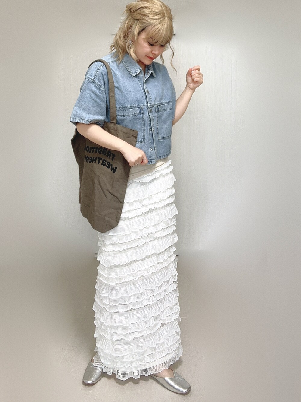 ブルー系のシャツ/ブラウス、ブラウン系のトートバッグ、ホワイト系のスカートを着用したレディースの夏コーディネートの3枚目の写真