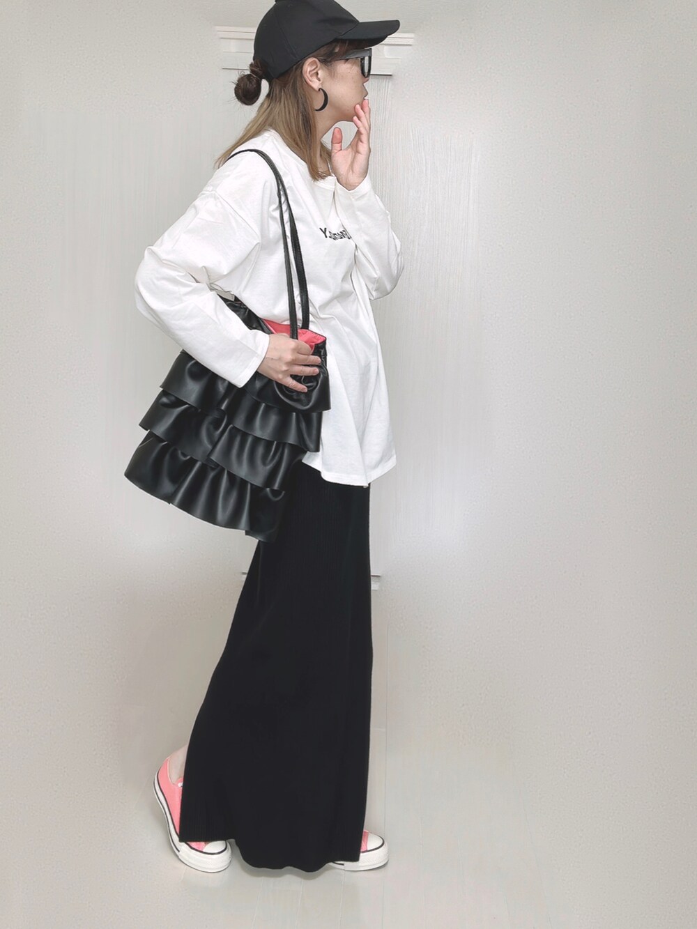 ブラック系のスカート、ピンク系のスニーカーを着用したレディースの秋コーディネートの2枚目の写真