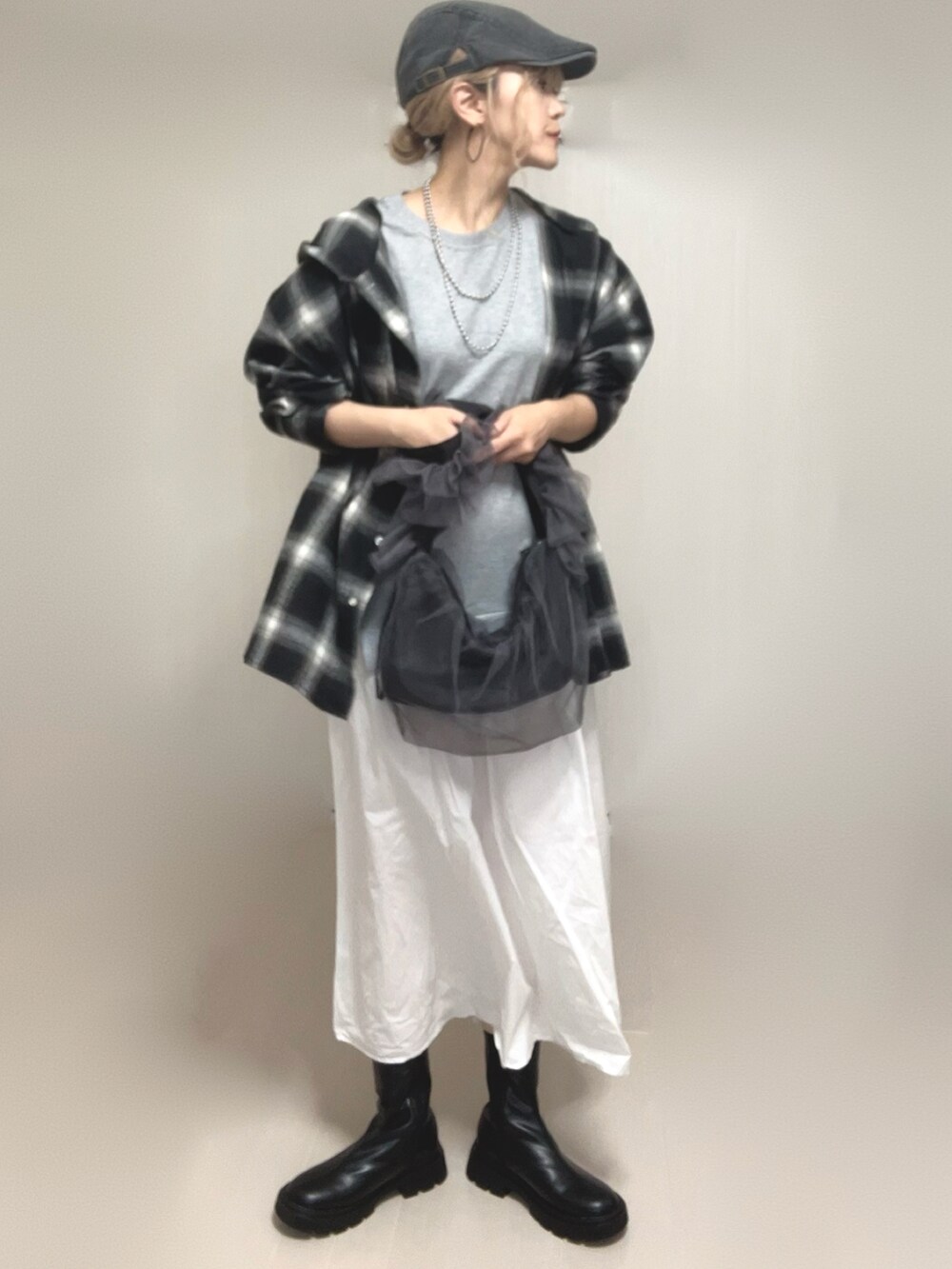ブラック系のシャツ/ブラウス、ブラック系のブーツ、グレー系のショルダーバッグを着用したレディースの夏コーディネートの4枚目の写真