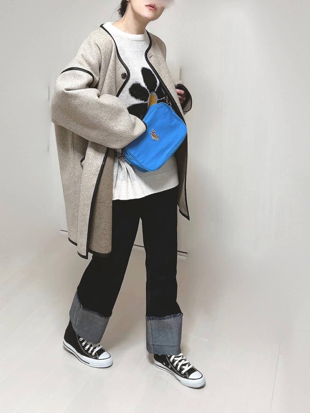 ブルー系のショルダーバッグ、ホワイト系のニット/セーター、ベージュ系のその他アウターを着用したレディースの冬コーディネートの5枚目の写真