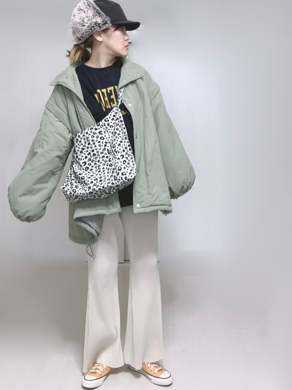 グリーン系のダウンジャケット/コート、ホワイト系のその他パンツ、ホワイト系のトートバッグを着用したレディースの冬コーディネートの2枚目の写真