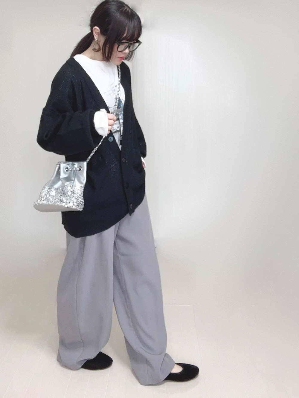 ブラック系のカーディガン/ボレロ、ホワイト系のTシャツ/カットソー、シルバー系のショルダーバッグを着用したレディースの春コーディネートの4枚目の写真