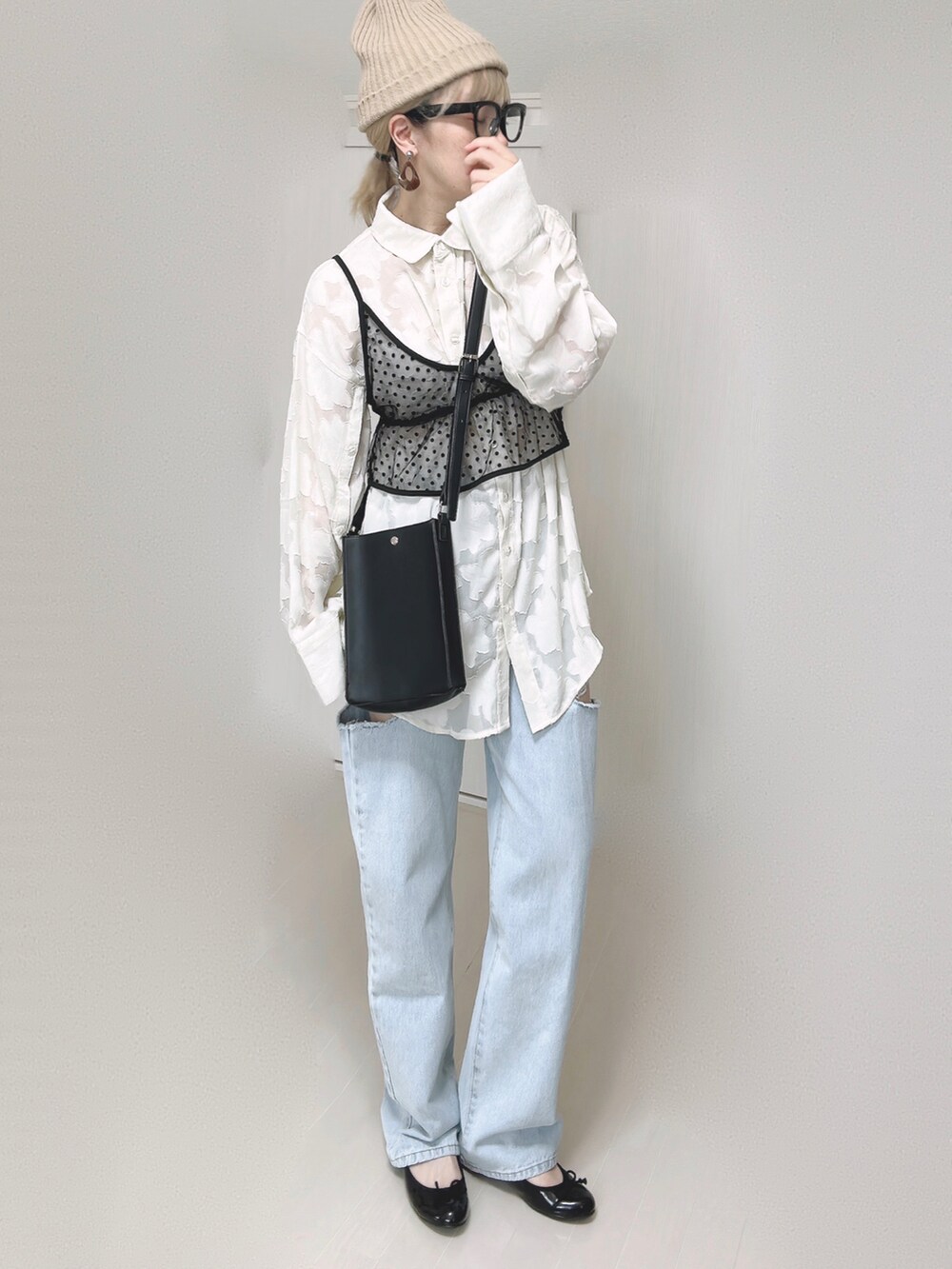 ブルー系のデニムパンツ、ホワイト系のシャツ/ブラウス、ブラック系のショルダーバッグを着用したレディースの夏コーディネートの4枚目の写真