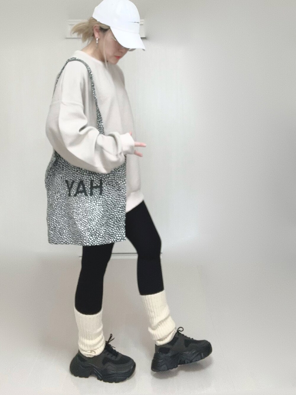 ベージュ系のTシャツ/カットソー、ブラック系のスニーカー、ホワイト系のアームカバーを着用したレディースの春コーディネートの3枚目の写真