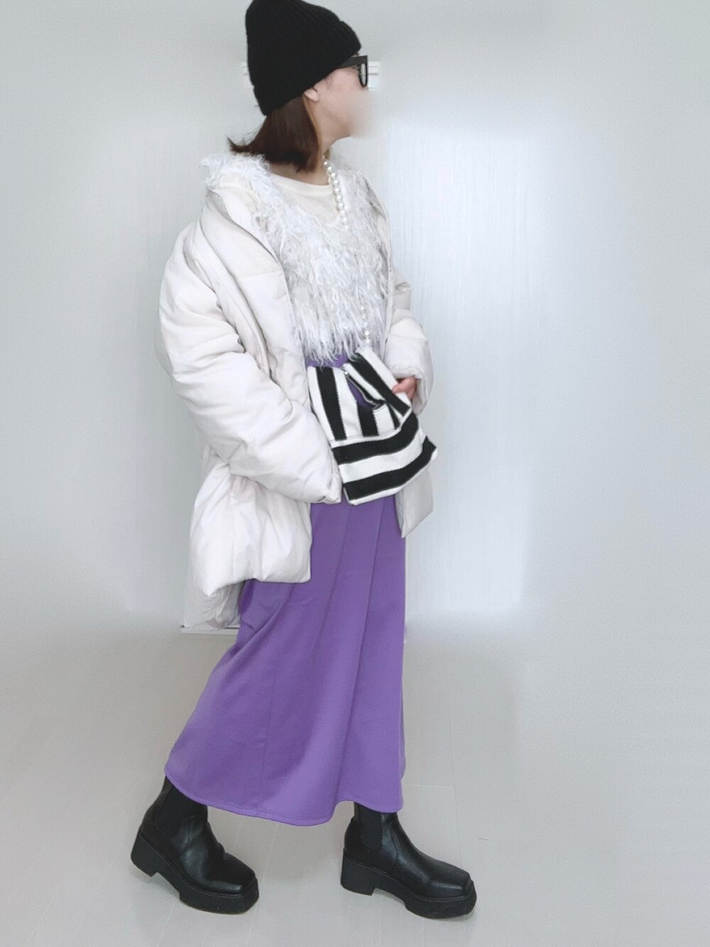 ホワイト系のTシャツ/カットソー、ホワイト系のベスト、ホワイト系のダウンジャケット/コートを着用したレディースの冬コーディネートの4枚目の写真