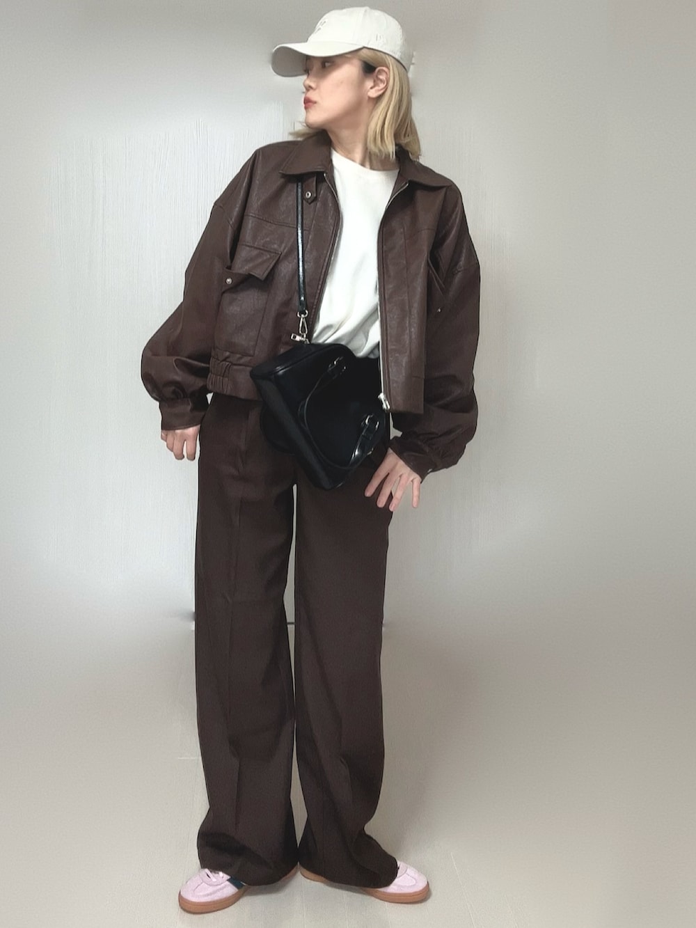 ブラウン系のブルゾン、ブラウン系のその他パンツ、ブラック系のボストンバッグを着用したレディースの冬コーディネートの3枚目の写真