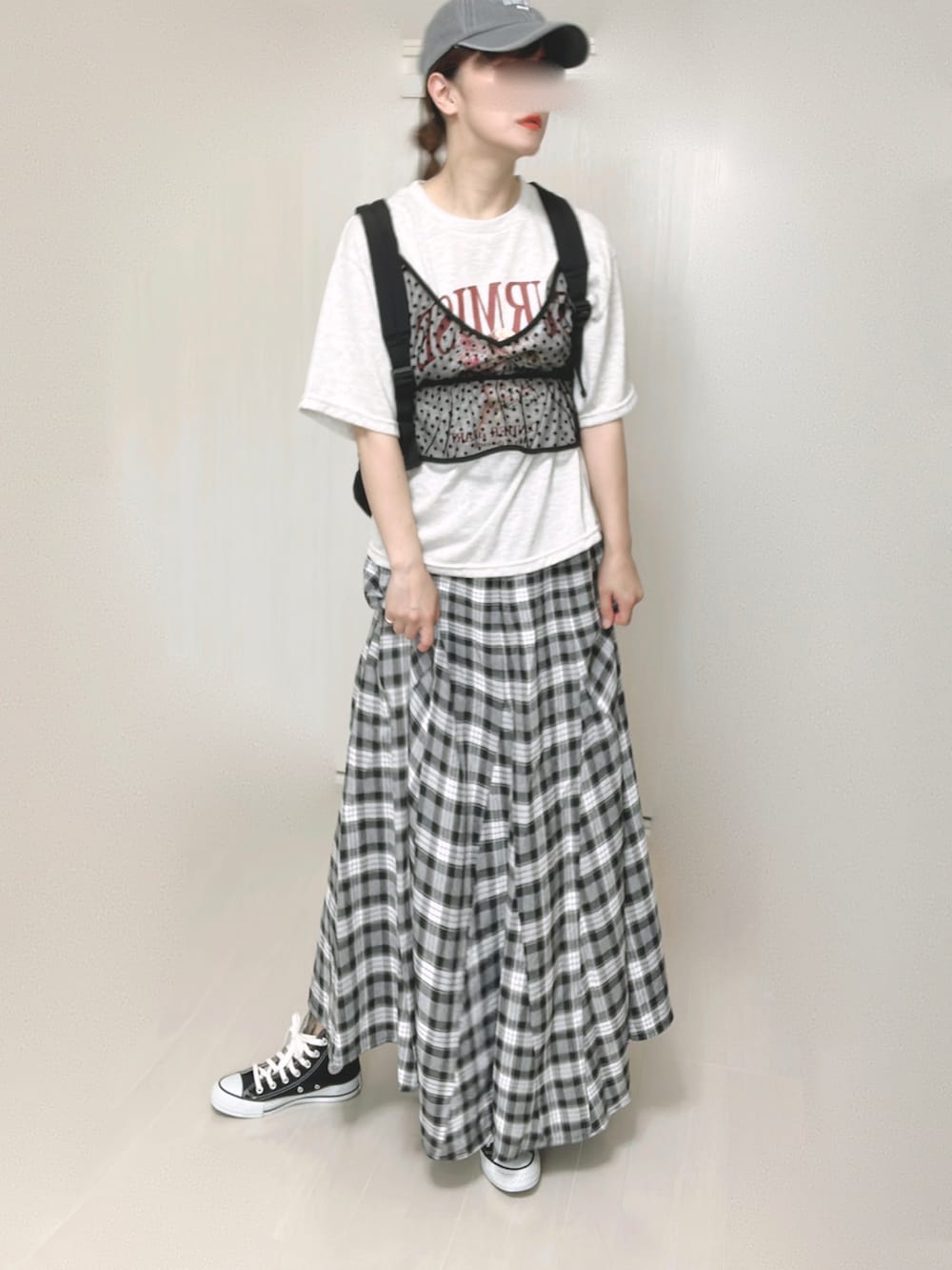 ブラック系のバックパック/リュック、ブラック系のスカート、ブラック系のスニーカーを着用したレディースの夏コーディネートの2枚目の写真