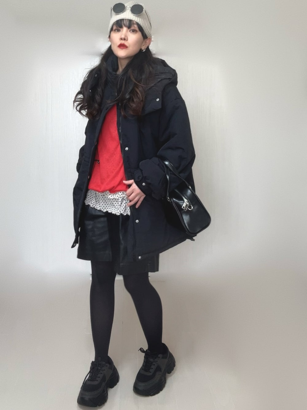 ホワイト系のTシャツ/カットソー、ブラック系のダウンジャケット/コート、レッド系のTシャツ/カットソーを着用したレディースの冬コーディネートの4枚目の写真