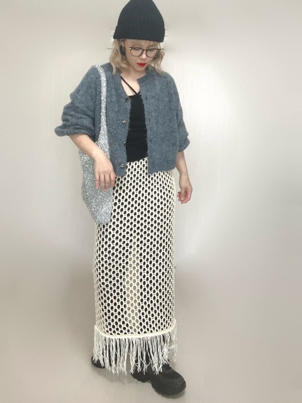 ブルー系のカーディガン/ボレロ、ブラック系のキャミソール、ホワイト系のスカートを着用したレディースの秋コーディネートの2枚目の写真