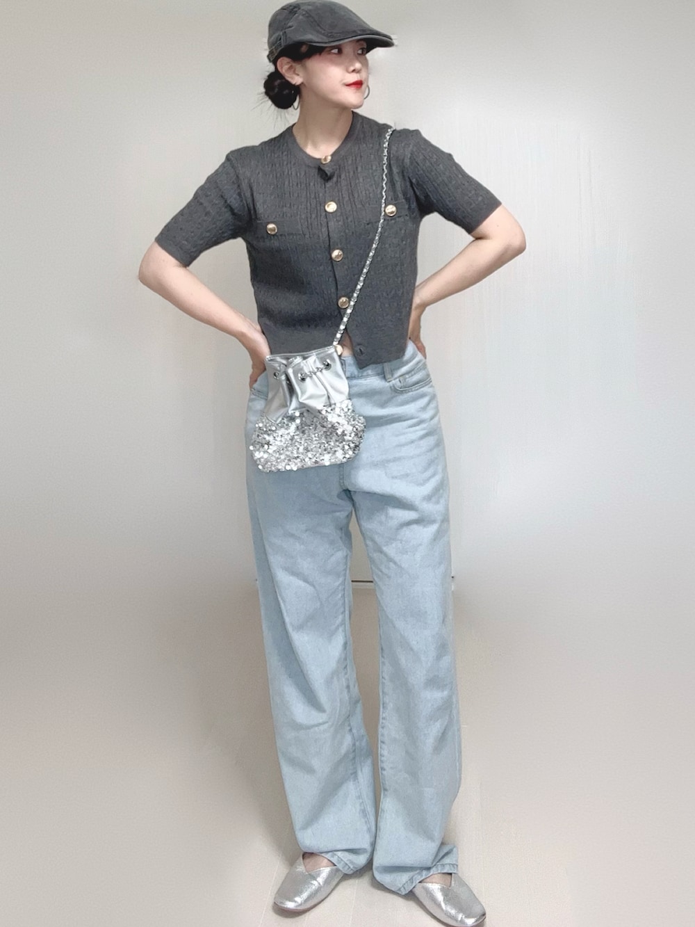 グレー系のカーディガン/ボレロ、シルバー系のパンプス、ブルー系のデニムパンツを着用したレディースの夏コーディネートの2枚目の写真