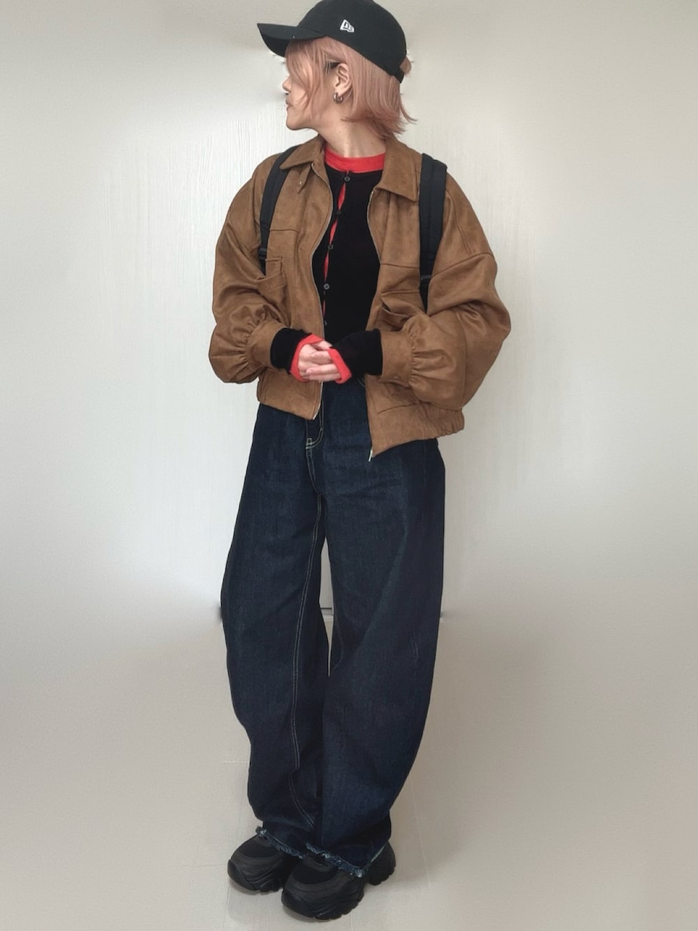 ブラック系のカーディガン/ボレロ、ベージュ系のブルゾン、レッド系のTシャツ/カットソーを着用したレディースの冬コーディネートの4枚目の写真