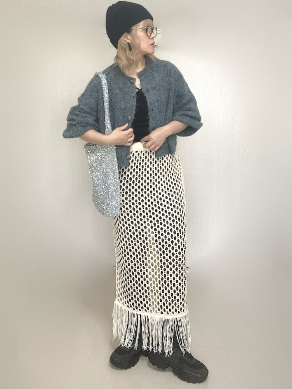 ブルー系のカーディガン/ボレロ、ブラック系のキャミソール、ホワイト系のスカートを着用したレディースの秋コーディネートの3枚目の写真