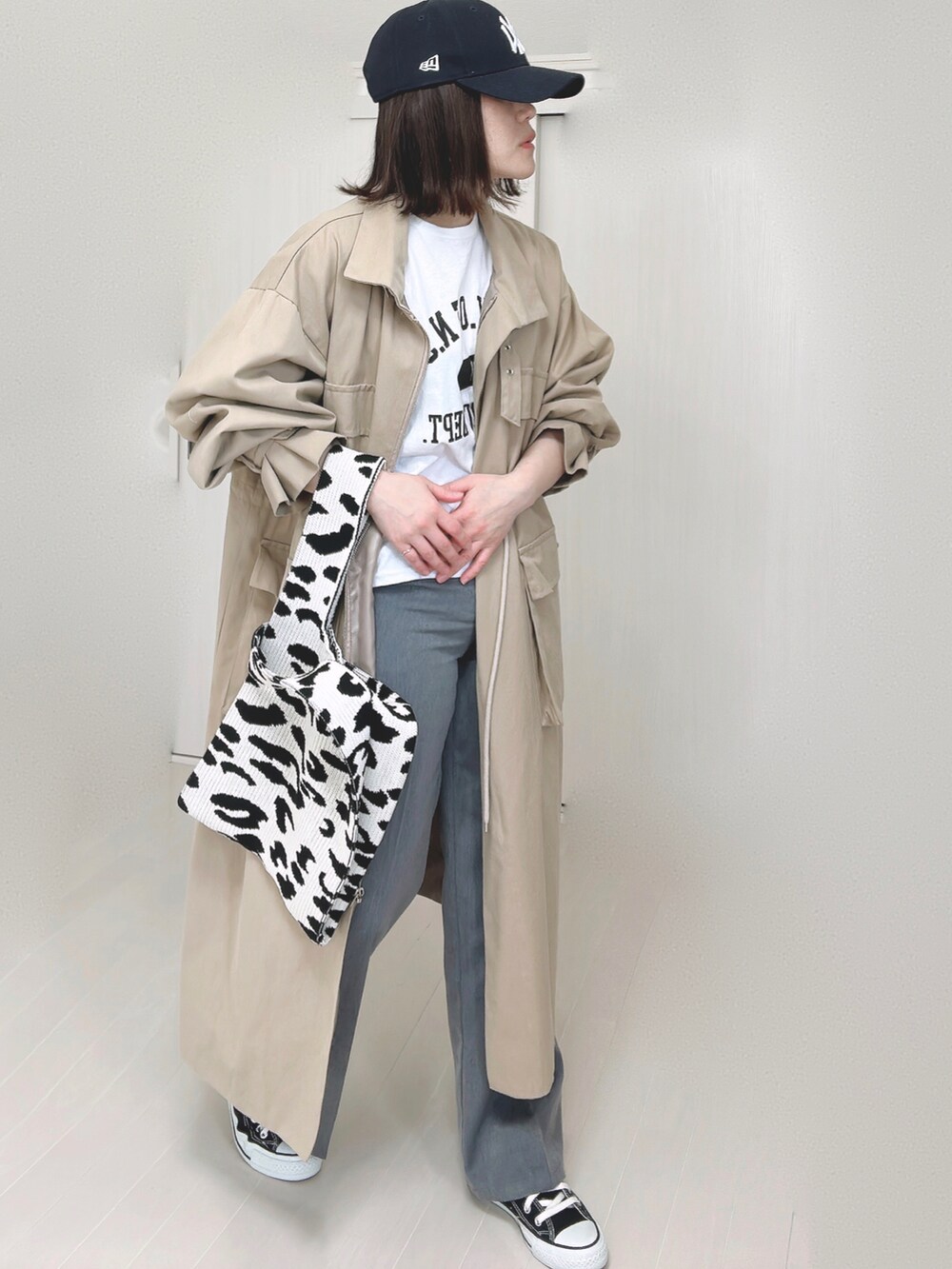 ホワイト系のTシャツ/カットソー、ベージュ系のその他アウター、ブラック系のスニーカーを着用したレディースの秋コーディネートの4枚目の写真