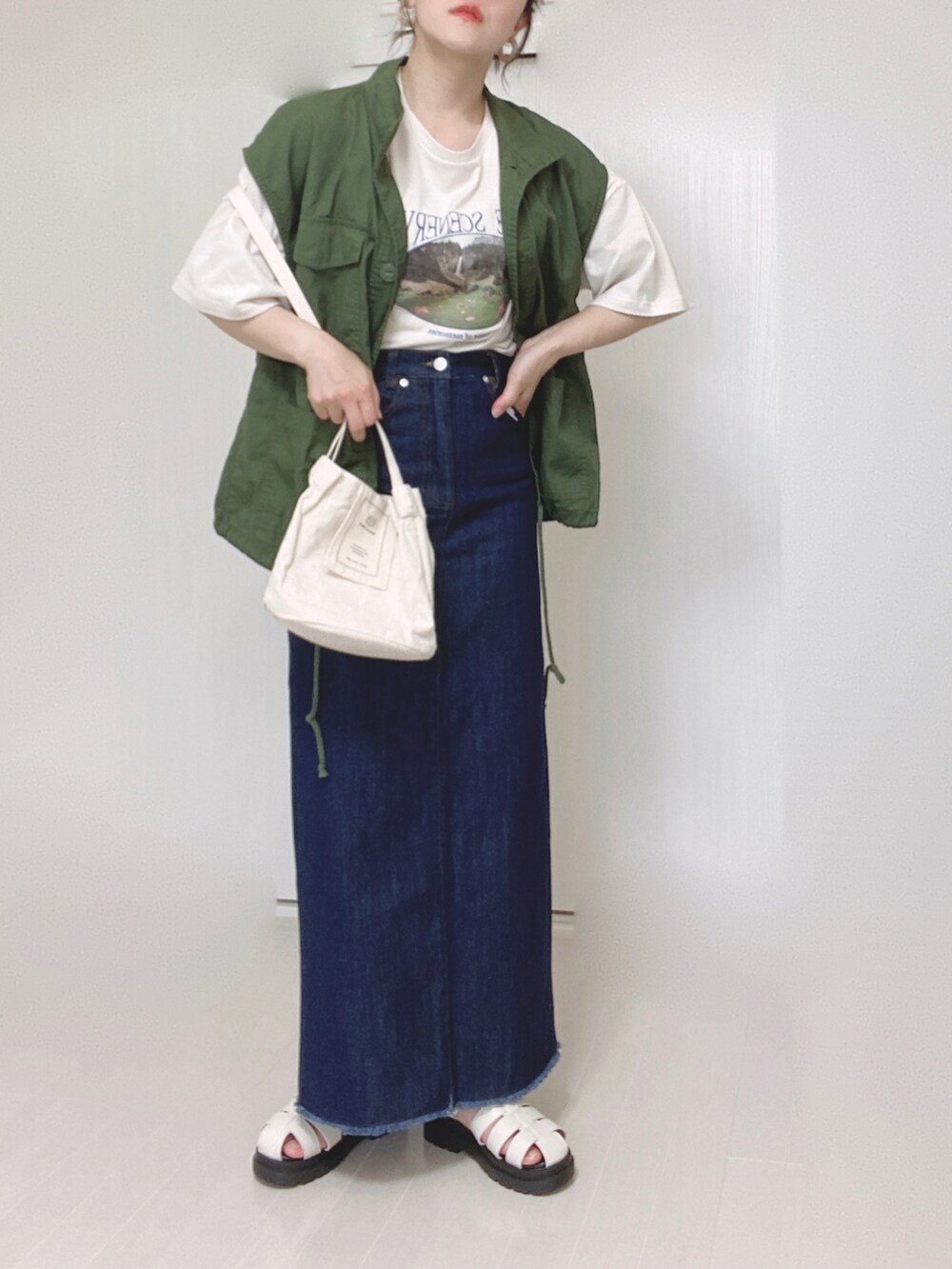 ホワイト系のTシャツ/カットソー、ブルー系のデニムスカート、グリーン系のその他アウターを着用したレディースの夏コーディネートの5枚目の写真