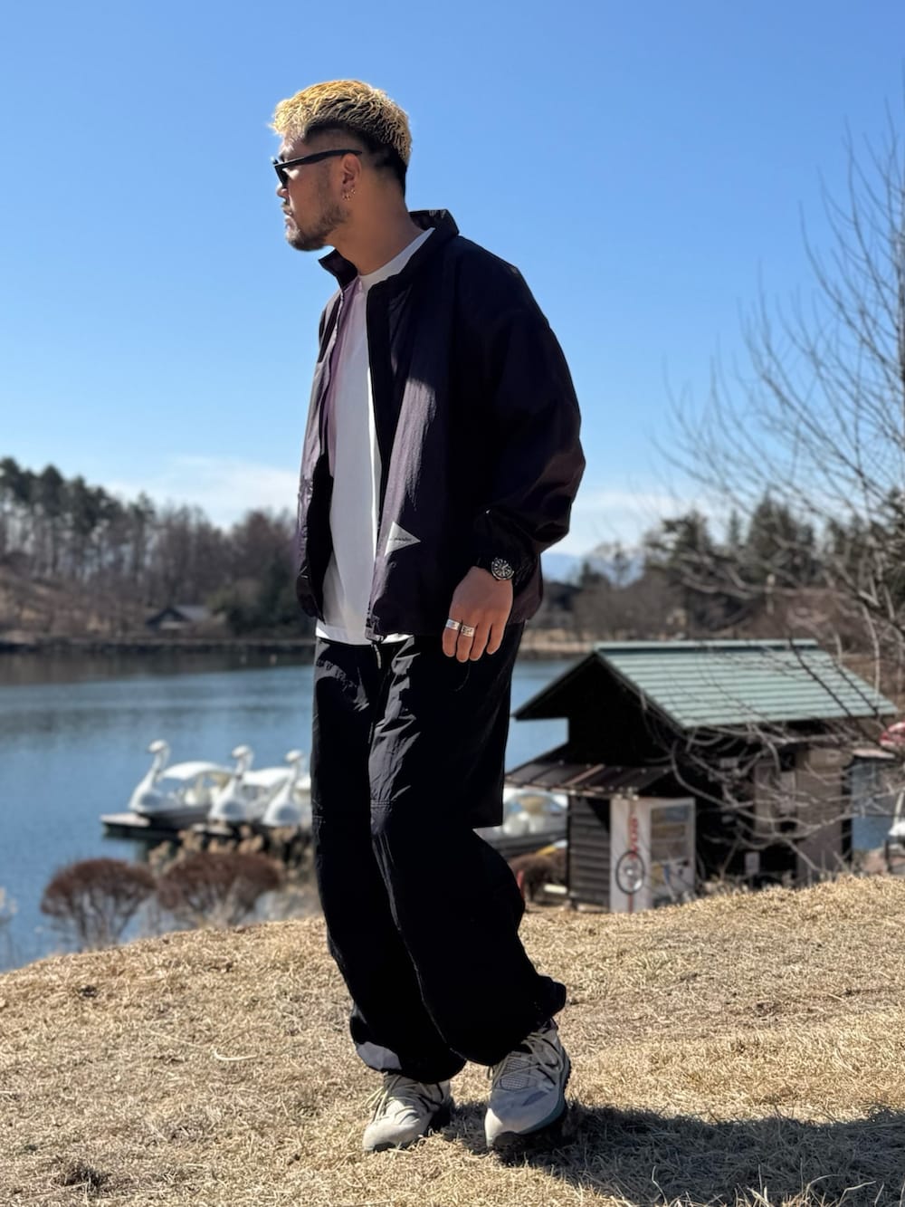 パープル系のテーラードジャケット、ブラック系のメガネを着用したメンズの春コーディネートの3枚目の写真