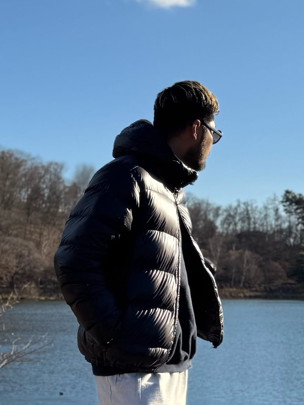 ブラック系のダウンジャケット/コート、ブラック系のメガネを着用したメンズの冬コーディネートの4枚目の写真