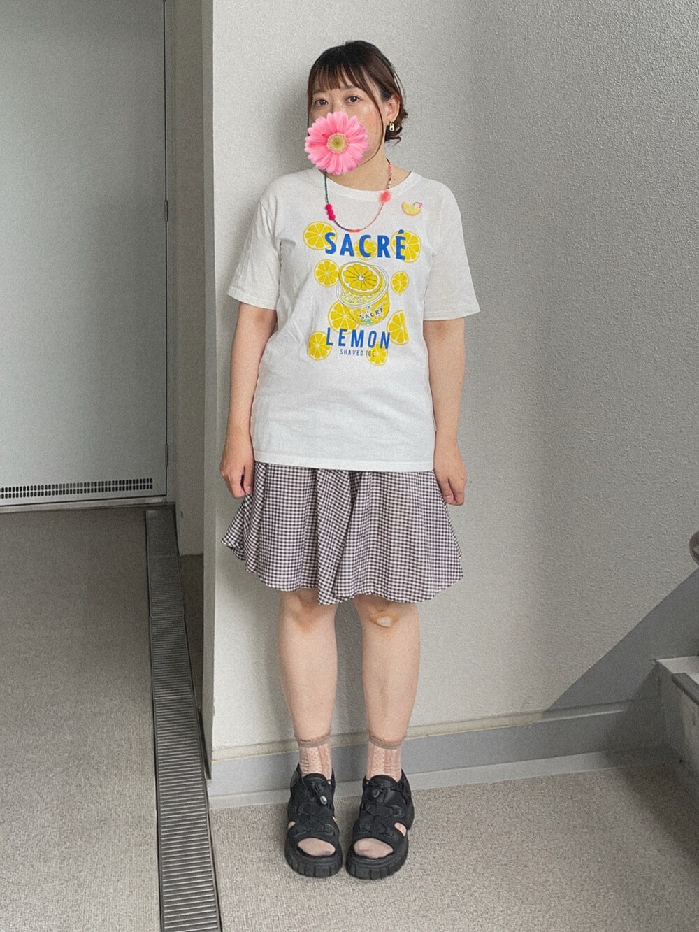 ホワイト系のTシャツ/カットソー、ブラウン系のスカート、ブラック系のサンダルを着用したレディースの秋コーディネートの2枚目の写真