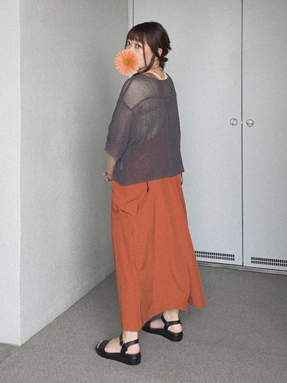 グレー系のTシャツ/カットソー、オレンジ系のジャンパースカート、ブラック系のサンダルを着用したレディースの夏コーディネートの3枚目の写真