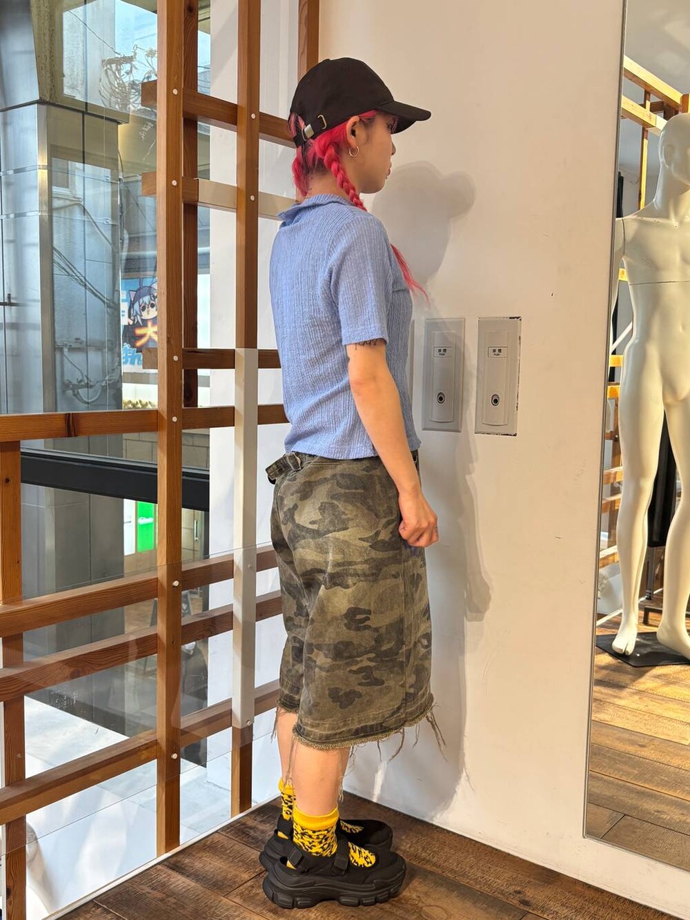 グリーン系のデニムパンツ、ブルー系のポロシャツ、ブラック系のタンクトップを着用したレディースの夏コーディネートの7枚目の写真