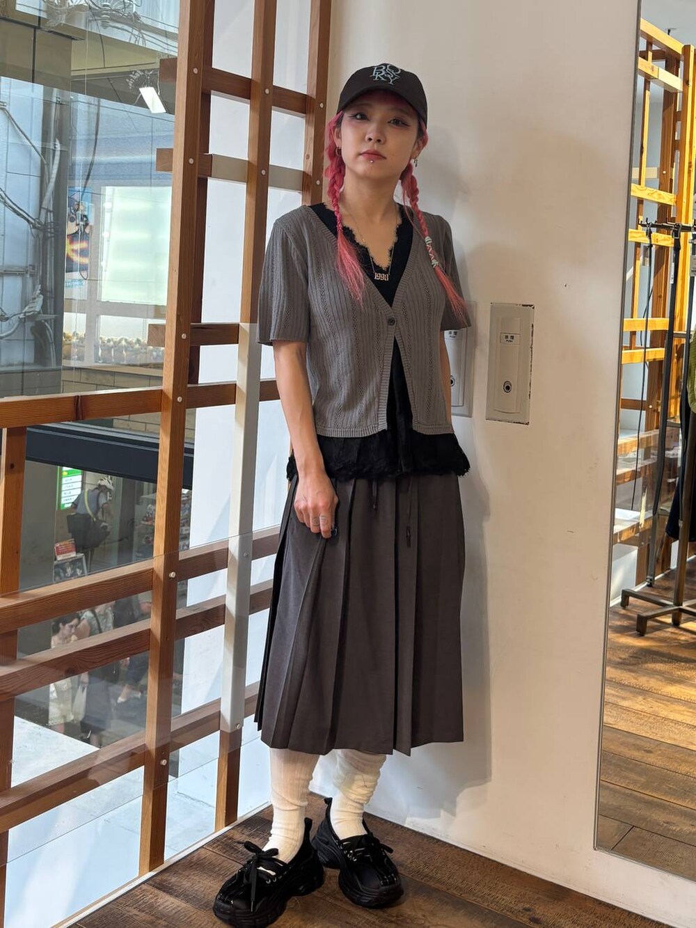 ブラック系のスリッポン、グレー系のTシャツ/カットソー、グレー系のスカートを着用したレディースの夏コーディネートの2枚目の写真