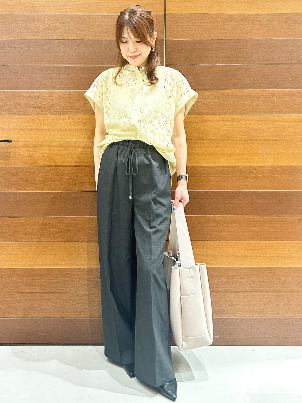 イエロー系のシャツ/ブラウス、グレー系のその他パンツ、グレー系のトートバッグを着用したレディースの夏コーディネートの3枚目の写真