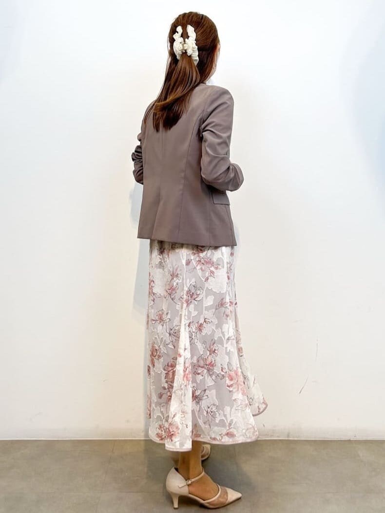 ブラウン系のテーラードジャケット、ホワイト系のTシャツ/カットソー、ベージュ系のスカートを着用したレディースの春コーディネートの6枚目の写真