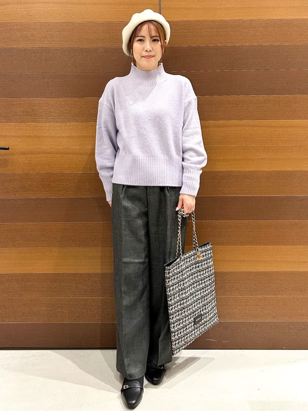 パープル系のニット/セーター、グレー系のその他パンツ、ブラック系のトートバッグを着用したレディースの冬コーディネートの3枚目の写真