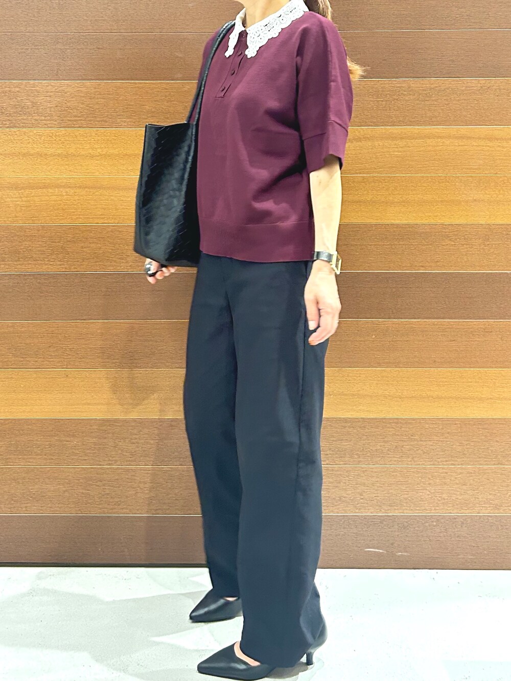 レッド系のニット/セーター、ブラック系のその他パンツ、ブラック系のトートバッグを着用したレディースの秋コーディネートの7枚目の写真