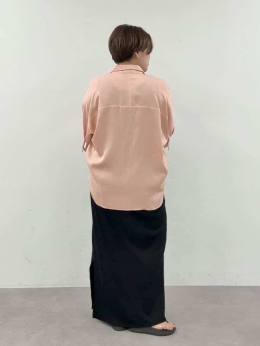ピンク系のシャツ/ブラウス、ブラック系のワンピース、ブラック系のトートバッグを着用したレディースの夏コーディネートの2枚目の写真