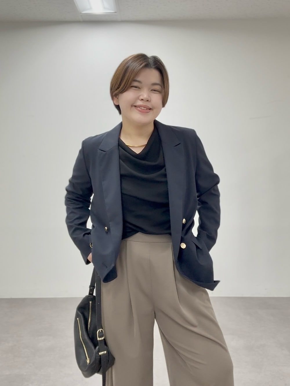 ブラック系のTシャツ/カットソー、ブラウン系のその他パンツ、ブルー系のテーラードジャケットを着用したレディースの春コーディネートの3枚目の写真