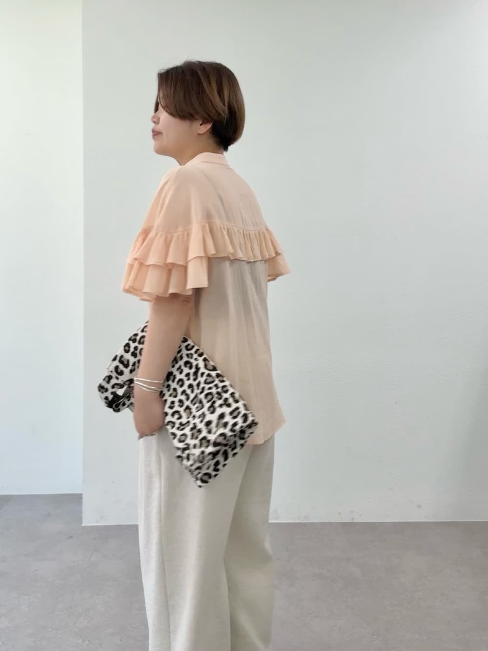 ピンク系のシャツ/ブラウス、ベージュ系のその他パンツ、ベージュ系のトートバッグを着用したレディースの春コーディネートの5枚目の写真