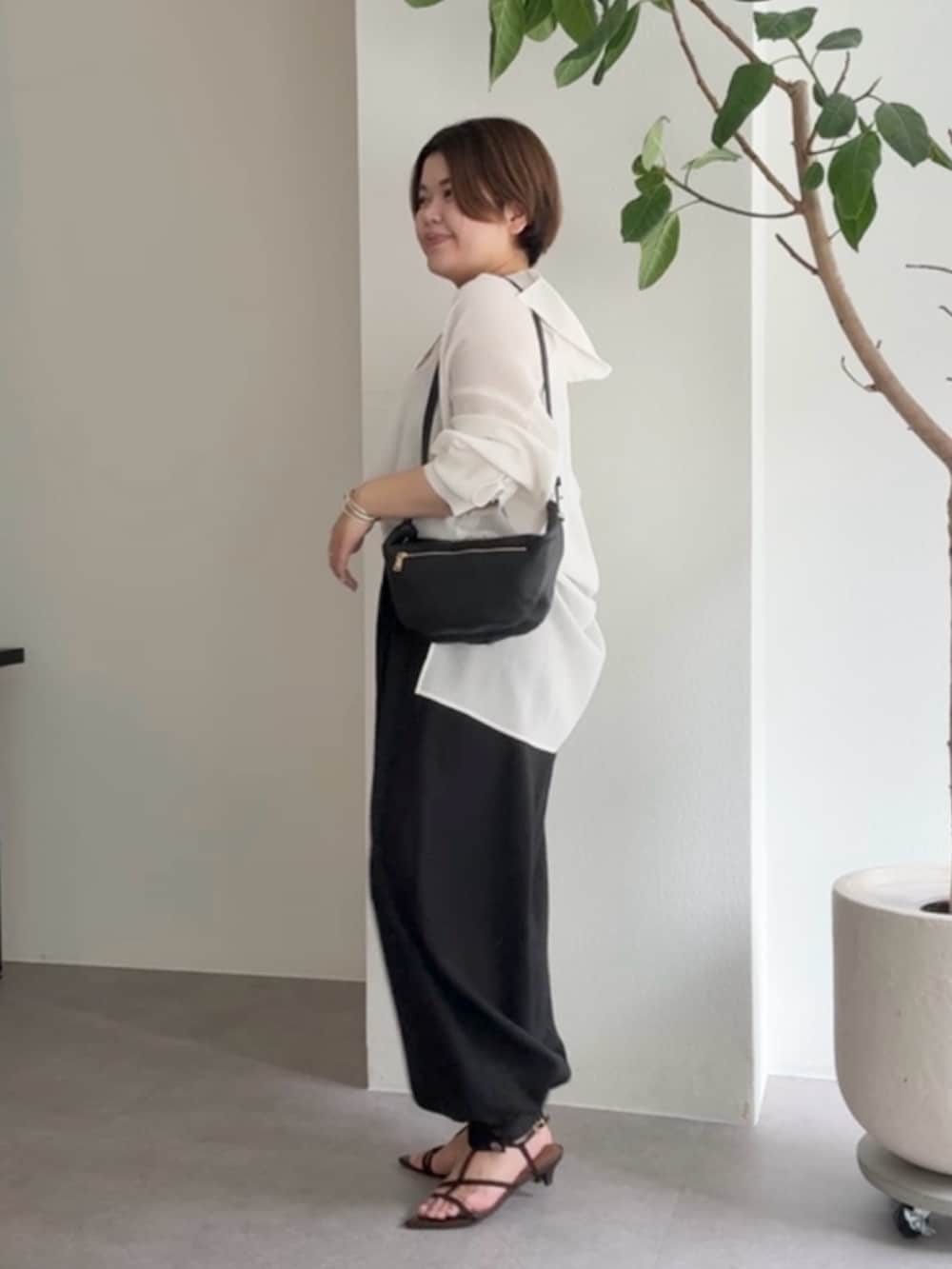 ホワイト系のシャツ/ブラウス、ブラック系のその他パンツ、ブラック系のショルダーバッグを着用したレディースの春コーディネートの2枚目の写真