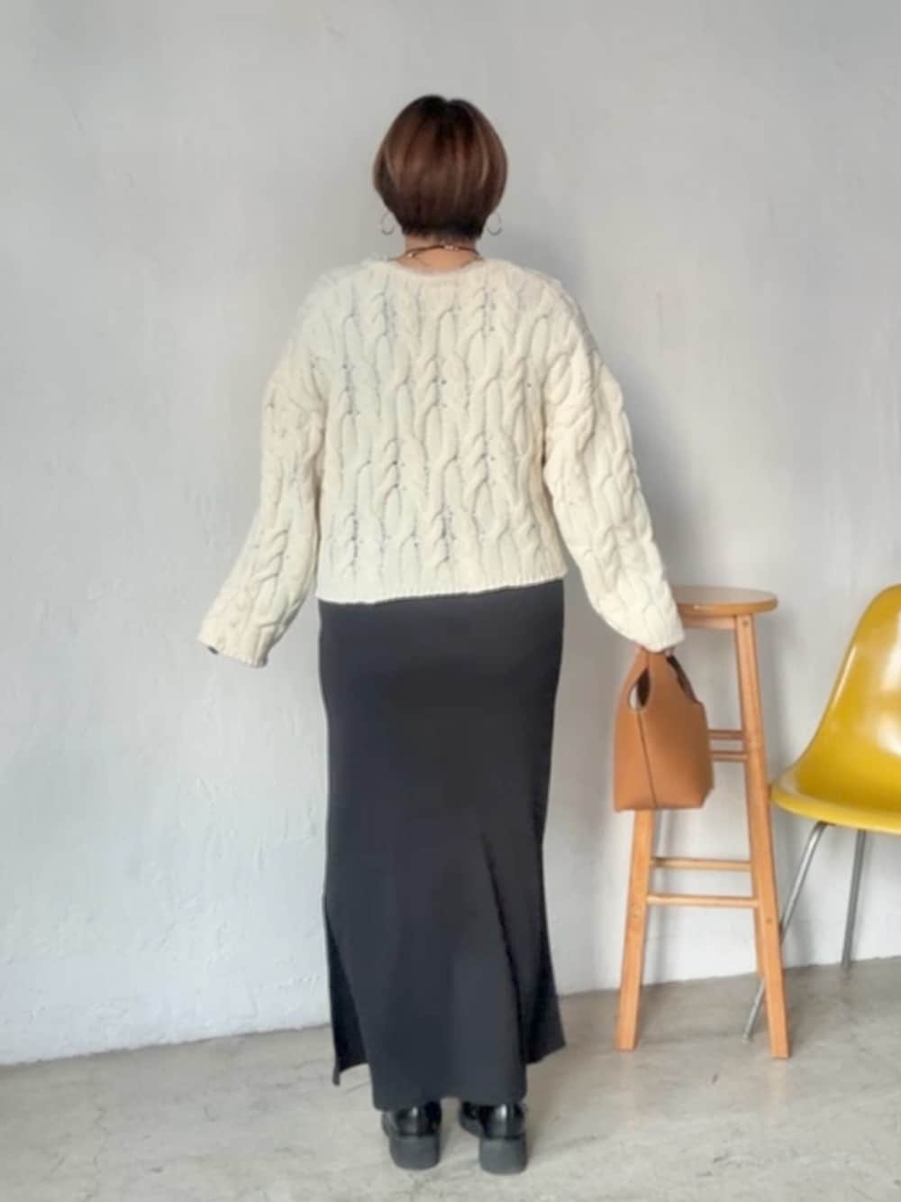 ホワイト系のニット/セーター、ブラック系のワンピースを着用したレディースの冬コーディネートの3枚目の写真