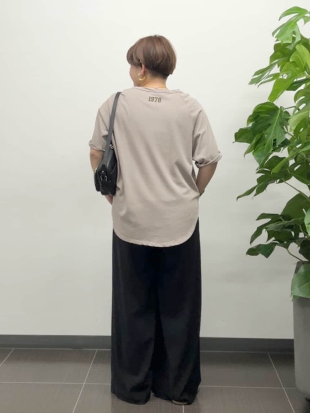 ブラウン系のTシャツ/カットソー、ブラック系のスラックスを着用したレディースの夏コーディネートの3枚目の写真