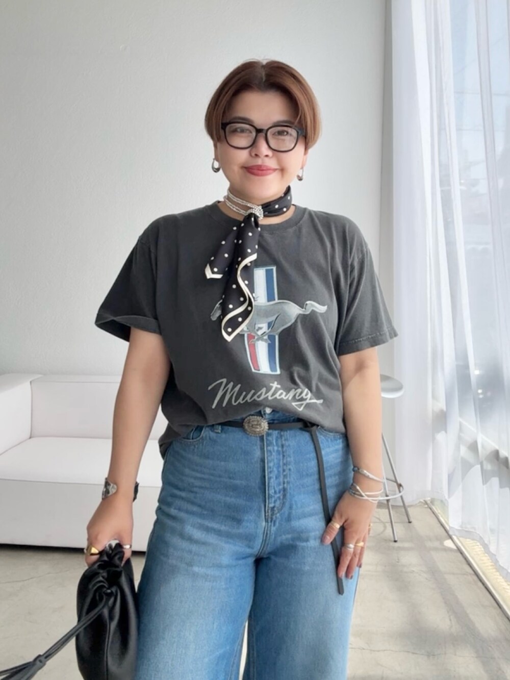 ブルー系のデニムパンツ、ブラック系のベルト、ブラック系のバンダナ/スカーフを着用したレディースの夏コーディネートの3枚目の写真