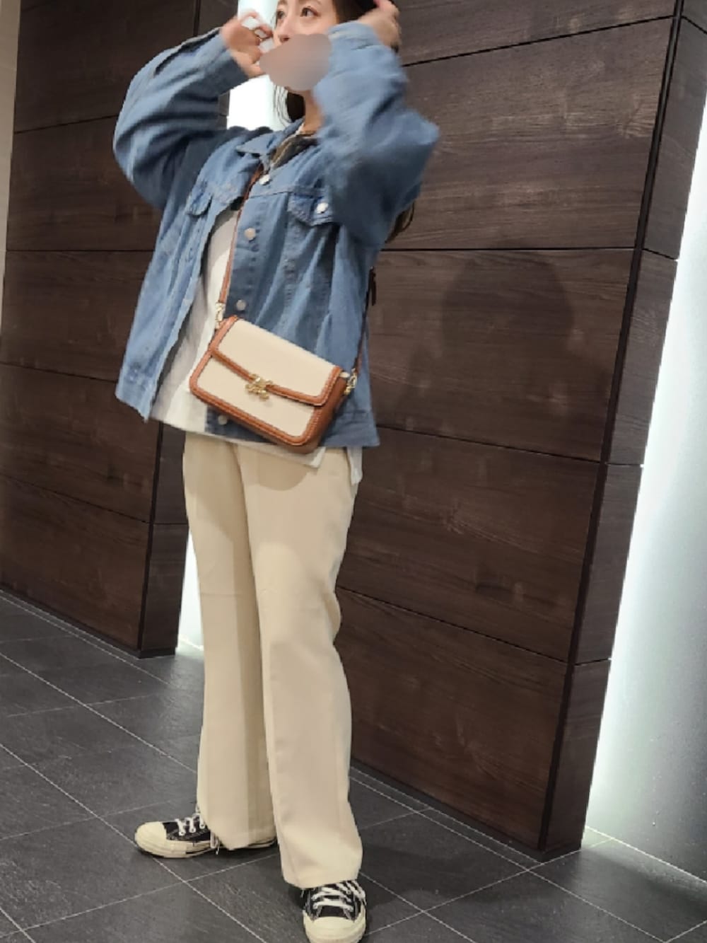 ブルー系のデニムジャケット、イエロー系のショルダーバッグ、ベージュ系のその他パンツを着用したレディースの秋コーディネートの2枚目の写真