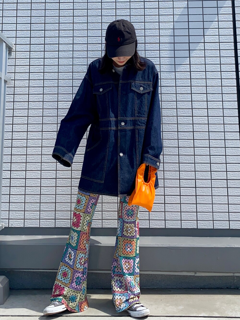 ブルー系のデニムジャケット、オレンジ系のハンドバッグ、その他のその他パンツを着用したレディースの春コーディネートの2枚目の写真