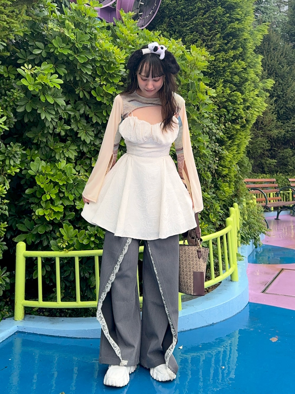 ホワイト系のシャツ/ブラウス、グレー系のスラックス、ブラウン系のショルダーバッグを着用したレディースの秋コーディネートの2枚目の写真