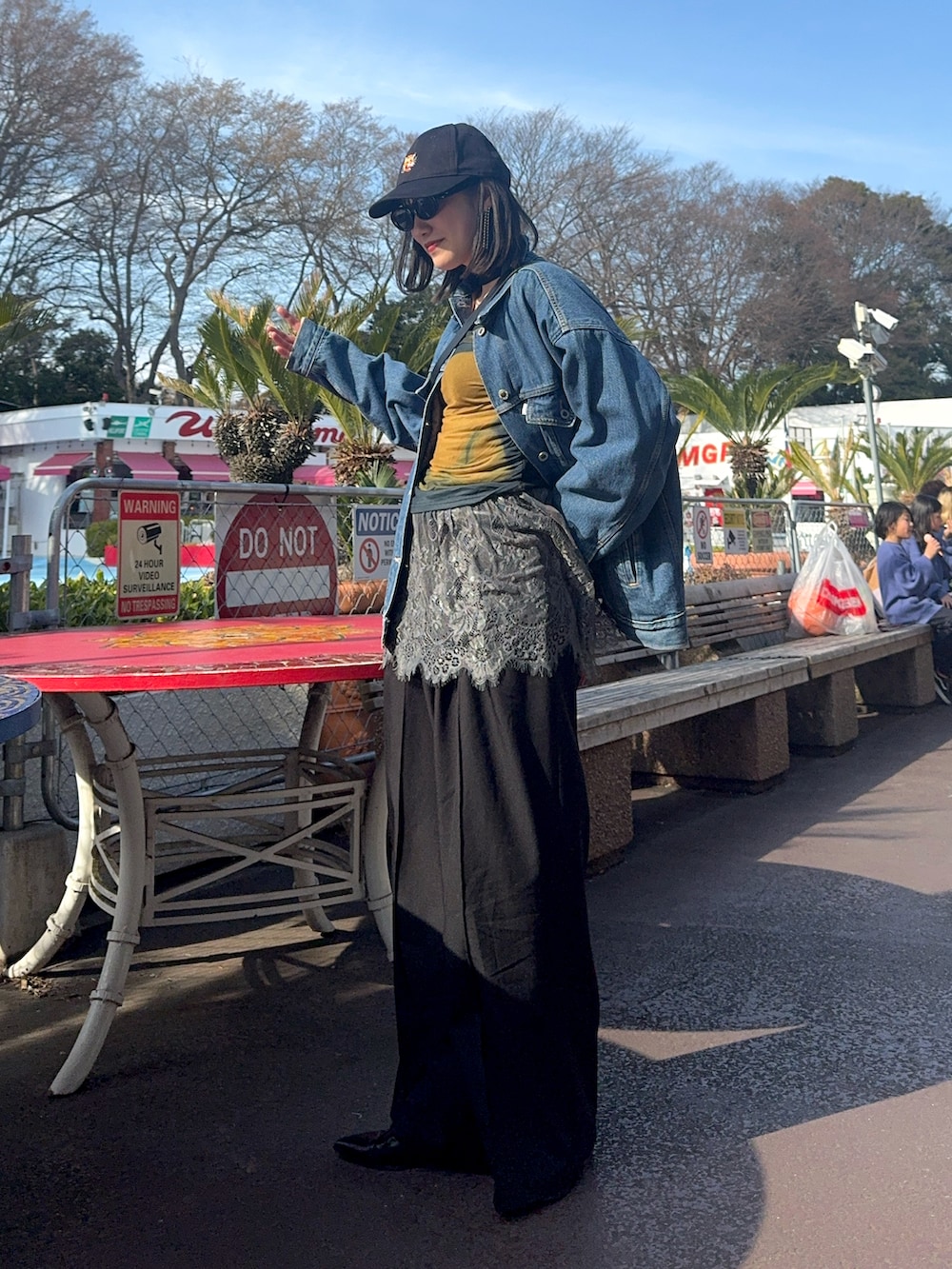 ブラック系のスラックス、ブルー系のデニムジャケット、ブラック系のボディバッグ/ウエストポーチを着用したレディースの春コーディネートの3枚目の写真