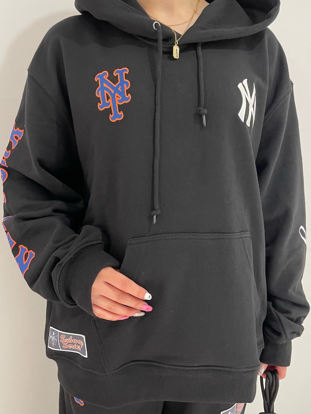 ブラック系のショルダーバッグ、ブラック系のパーカー、ブラック系のスウェットパンツを着用したレディースの夏コーディネートの4枚目の写真