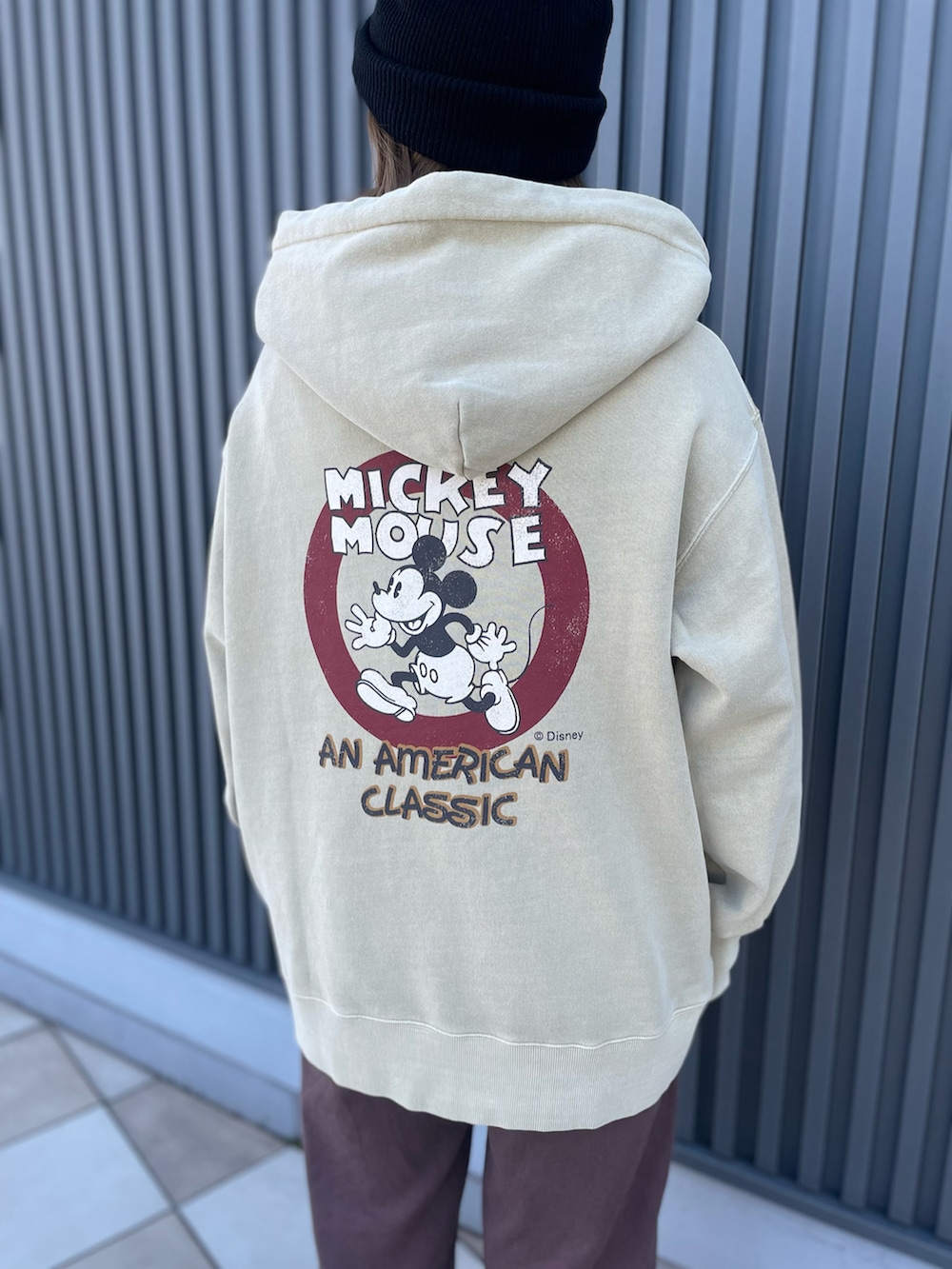 ベージュ系のパーカー、ブラック系のニットキャップ/ビーニーを着用したレディースの秋コーディネートの2枚目の写真