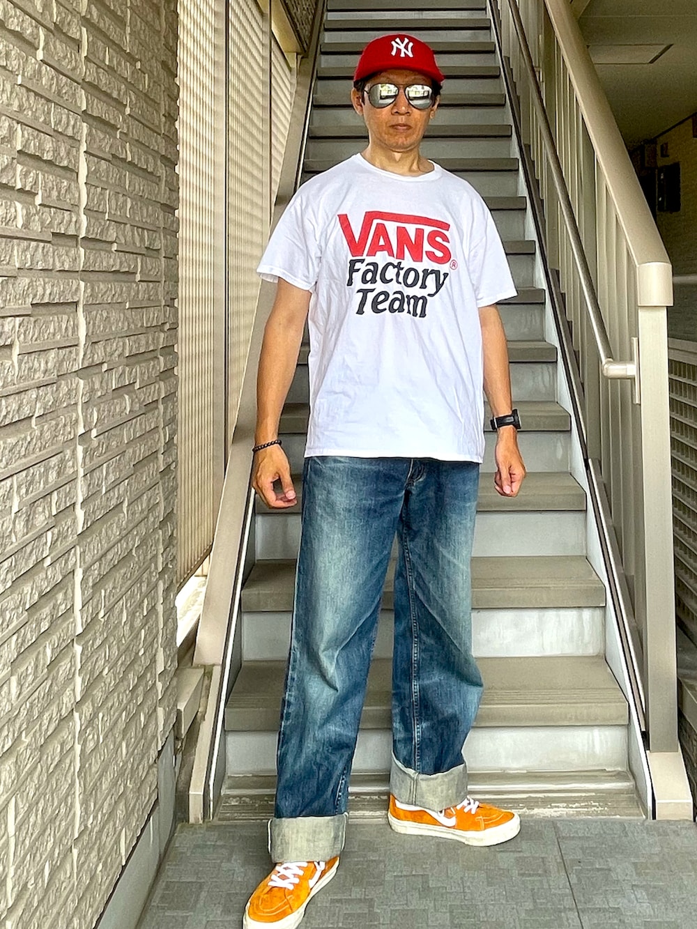 ホワイト系のTシャツ/カットソー、イエロー系のトートバッグ、ブルー系のデニムパンツを着用したメンズの夏コーディネートの2枚目の写真