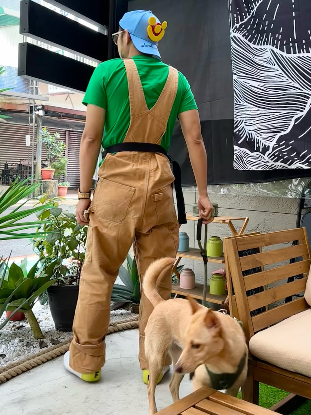 ブラウン系のサロペット/オーバーオール、イエロー系のスニーカー、イエロー系のボディバッグ/ウエストポーチを着用したメンズの春コーディネートの3枚目の写真