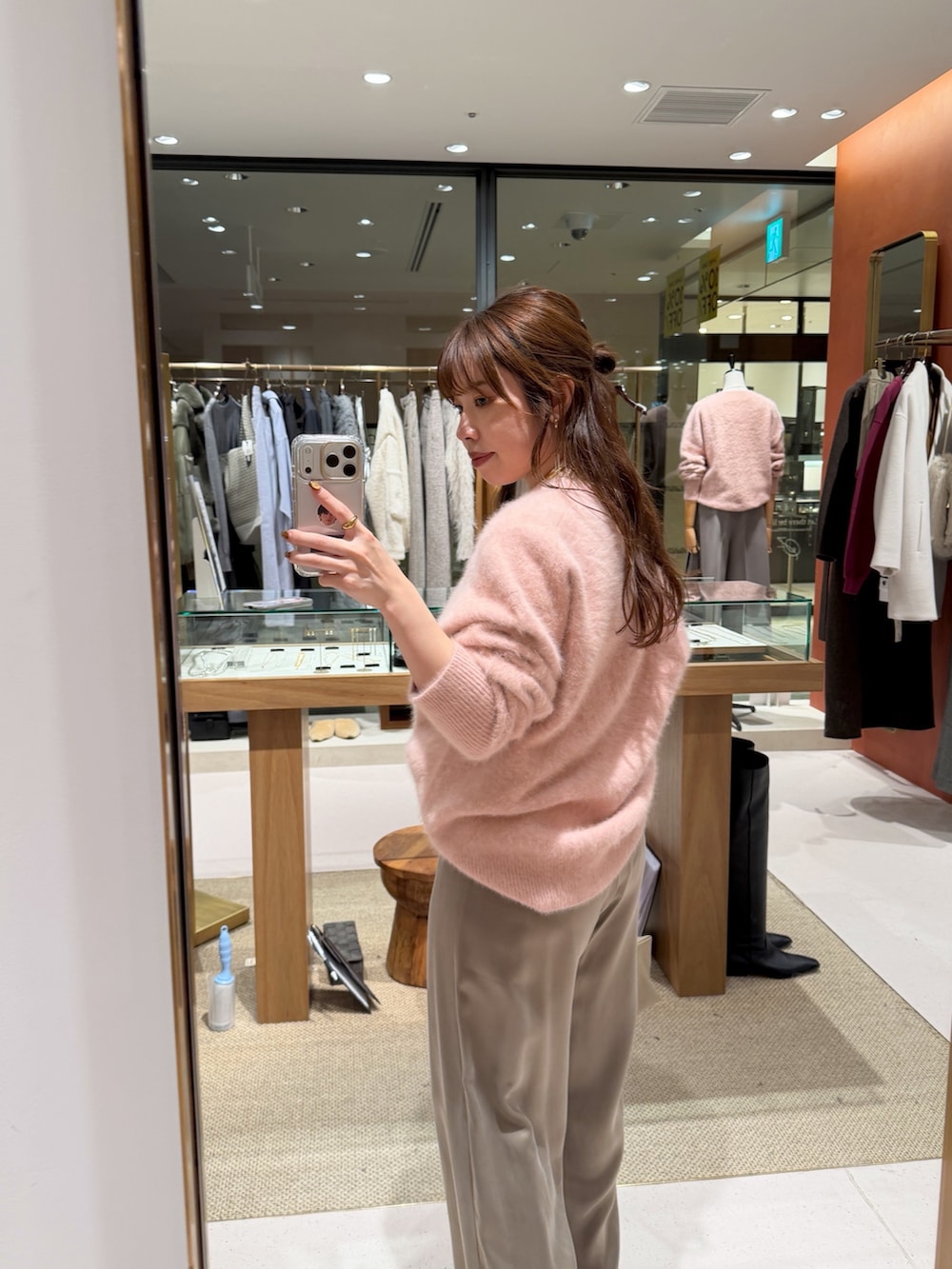 ピンク系のニット/セーター、ベージュ系のハンドバッグ、ベージュ系のその他パンツを着用したレディースの秋コーディネートの3枚目の写真